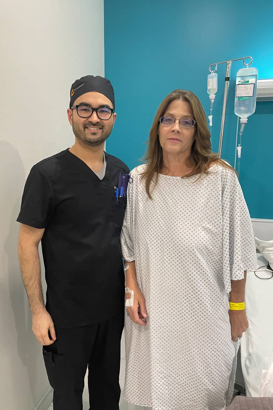 A man and a woman, both in clinical attire, posing with seriousness and professionalism.