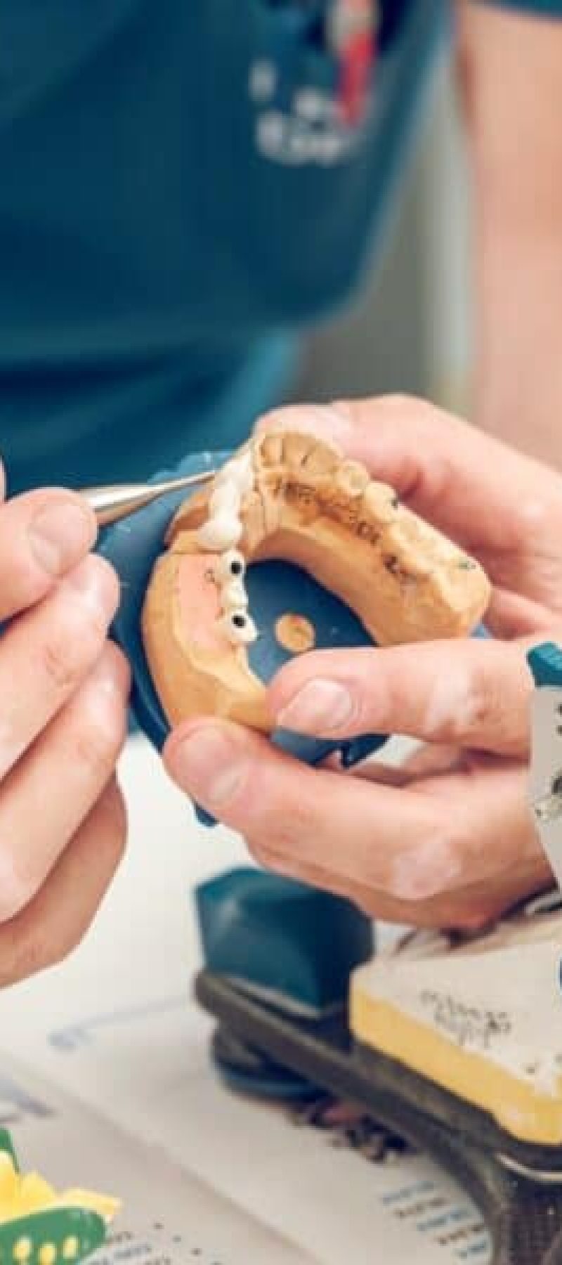 Crop man dental technician using tools making implant jaws Crop man dental technician using tools making implant jaws